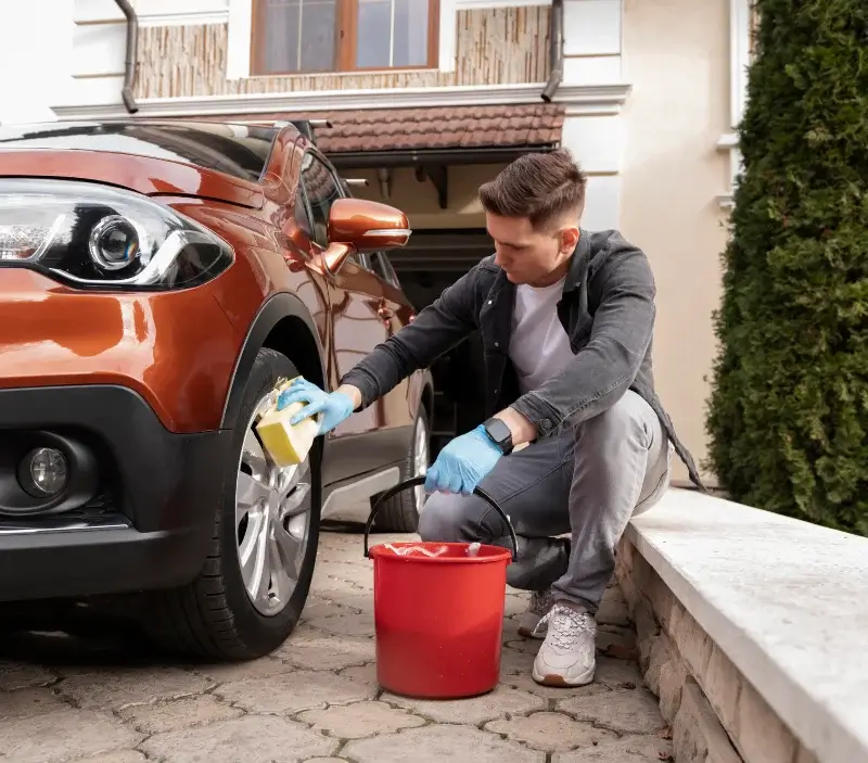 Lavage auto à domicile Saint-Bômer-les-Forges : professionnel intervenant sur un véhicule